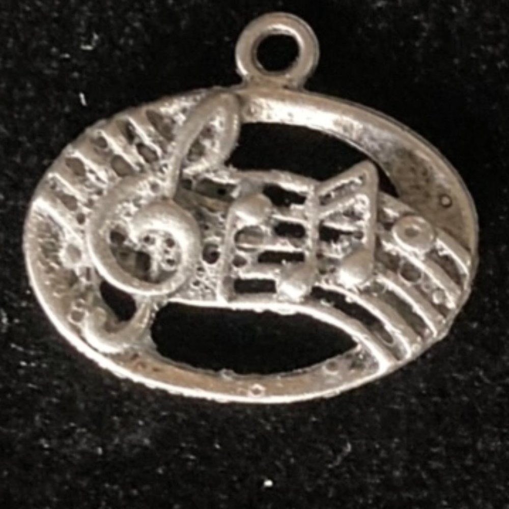 Free with purchase. Music notes charm